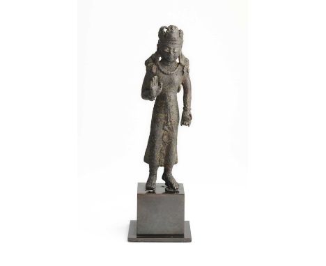 A SWAT VALLEY BRONZE FIGURE OF MAITREYA, KHYBER PAKHTUNKHWA, PAKISTAN, CIRCA 7TH CENTURY  the slender figure standing with ri