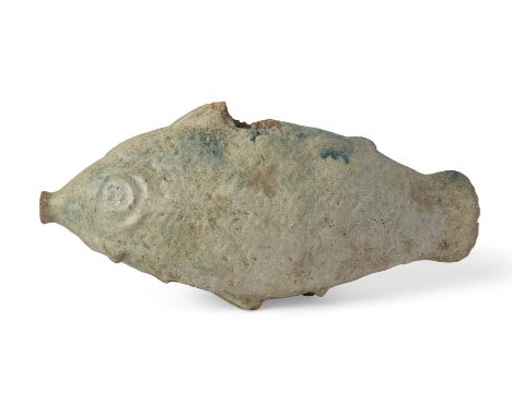 A large hollow Parthian turquoise glazed ceramic fish rhyton circa 2nd-3rd Century A.D., set on four fins, with a trumpet-sha