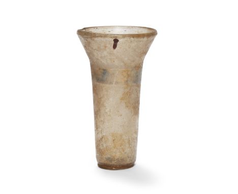 A Mamluk gilt-decorated glass beaker, Syria, 13th century, of cylindrical form widening to the vertical mouth, remains of a s