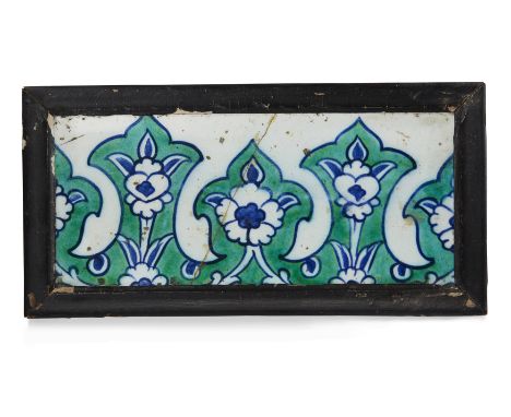 A Damascus Iznik rectangular border pottery tile, Ottoman Syria, 17th century, the blue and green painted decoration consisti