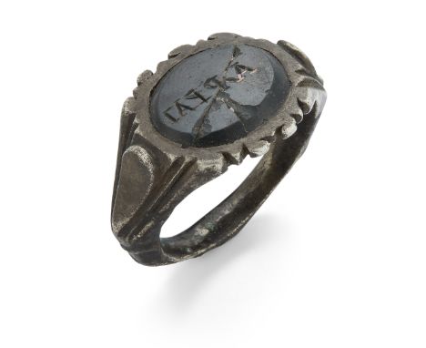 A Roman silver ring with broad engraved shank, the green bezel engraved with lettering, circa 3rd Century A.D., 2.3 cm diamet