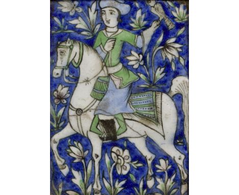 A rectangular moulded pottery tile, Qajar Iran, 19th century, The green, cobalt blue and black painted decoration consisting 