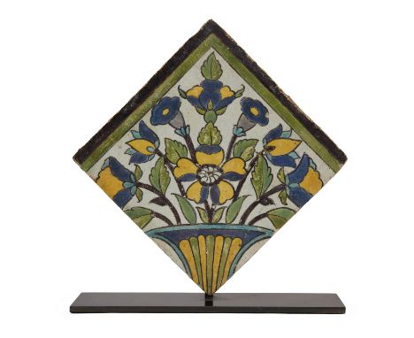 A Square Cuerda Seca Corner Pottery Tile, Safavid Iran, 17th century, the polychrome painted decoration consisting of a large