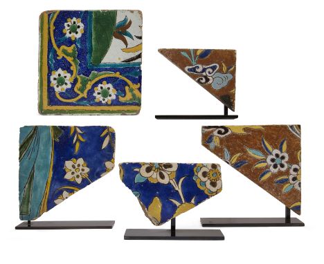 A Square Corner Pottery Tile and Four Fragmentary Cuerda-Seca Pottery Tiles, Iran, 17th century, the first with painted decor