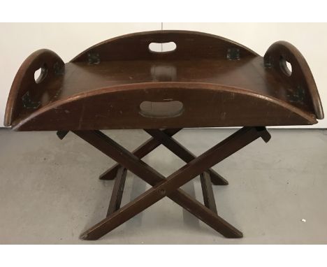 A vintage dark wood butlers tray with folding sides and brass hinges. Stand has one strap replaced. Total height on stand app