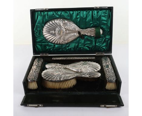 An early 20th century silver dresser set, Edmund Bennett, London, 1904/5, comprising hand mirror, two dress brushes, two hair