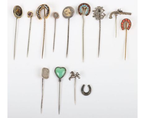 Twelve 19th century and later stick pins, various types including horseshoe, fox, pistol, with a loose horseshoe, (13)