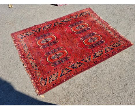 A Persian Rug of multi-bordered design, with four panels to the centre on a red ground, 9ft 5in x 6ft 10inCondition Report - 