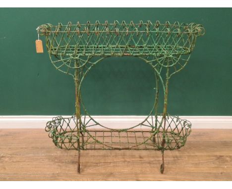 A Victorian green painted wirework Jardiniere/Plant Stand, with two tiers, scrolled and circular designs and raised on four s