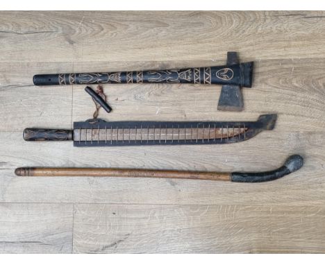 An Aboriginal type Axe with figural and geometric carved shaft, a long bladed Knife with carved handle and a lead loaded Cudg