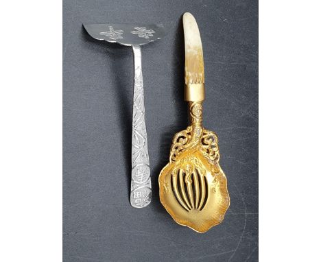 A Chinese silver Pusher decorated bamboo, and a sterling silver-gilt Sifting Spoon with leafage scroll design