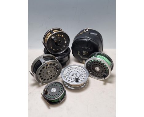 Four Fishing Reels to include, a Hardy Bros "The St George" 3" Trout Fly Reel with black handle, ventilated spool and ribbed 