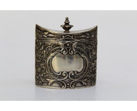 A 19th century Continental white metal tea caddy of navette oval form, repousse decorated around a vacant cartouche, knop fin
