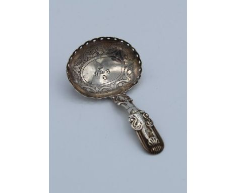 John Bettridge, an early 19th century silver caddy spoon with fiddle, shell scrolled handle and pierced, swag decorated oval 