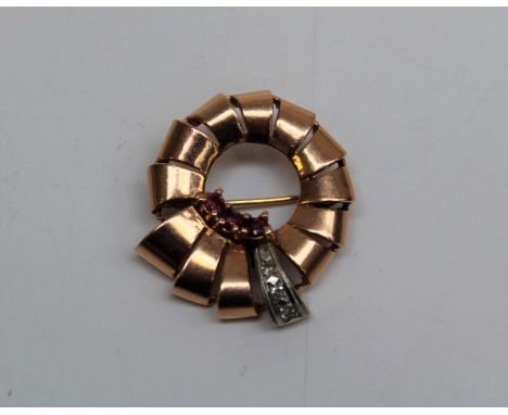A 14k stamped rose metal ruby and diamond set brooch. Approximate weight 11.7gm