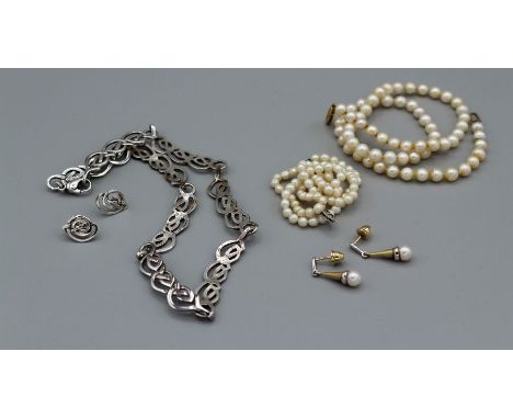 A selection of jewellery comprising two graduated strands of pearls, one with a 375 stamped clasp, a pair of yellow and white