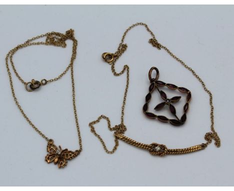 Two delicate yellow metal necklaces along with a 9c stamped garnet and seed pearl pendant