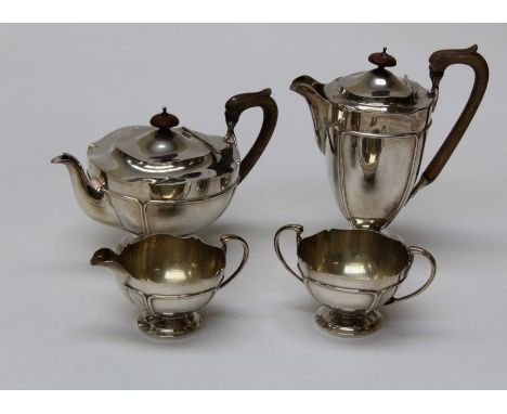 E S Barnsley and Co Ltd, a George v silver four piece tea service comprising tea and hot water pots, twin handled sugar and c
