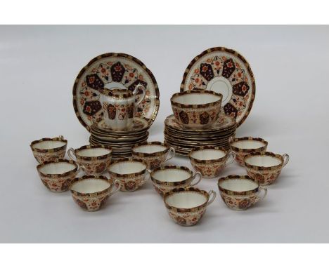 An Edwardian bone china part tea service, a twelve place setting, decorated in the Imari palette