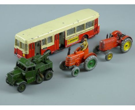 FOUR VINTAGE DINKY TOY VEHICLES to include a French made autobus 'Berliet', a recovery tractor in army livery, a Massey Harri