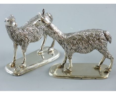 A PAIR OF STANDING LLAMA FIGURES, white metal with no visible markings on rectangular bases, 10 x 12 cms approximately