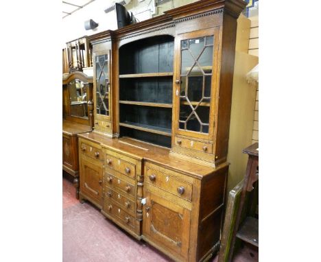 A GEORGIAN NORTH WALES OAK BREAKFRONT DRESSER with inverted stepped cornice and block pattern over a recessed three shelf Del