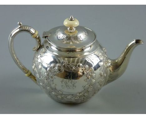 A LATE VICTORIAN SILVER BULLET SHAPED TEAPOT with bright cut embossed floral swags, ivory knop to lid and similar heat guards