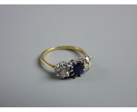 A LADY'S GOLD, SAPPHIRE & DIAMOND DRESS RING having a centre oval cut sapphire with two flanking diamonds, visual estimate of