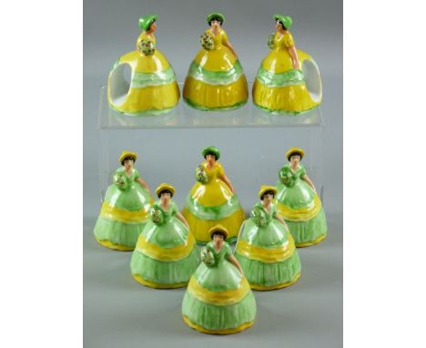 NINE CARLTONWARE NAPKIN RINGS all modelled as crinoline ladies, five with green dress, yellow ribbon and bonnet and four with
