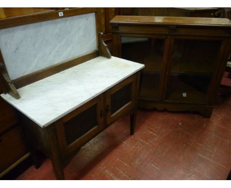 A MAHOGANY TWO DOOR BOOKCASE, late Victorian with simple carved corbel features, twin glazed doors with single interior shelf