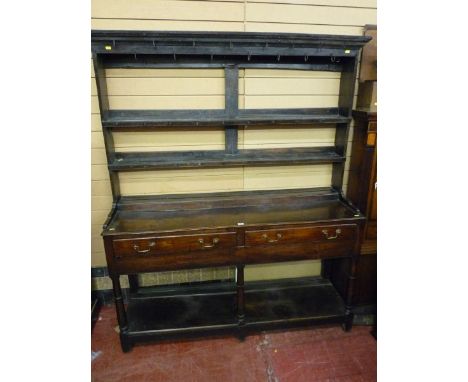 A 19th CENTURY OAK DRESSER in the Shropshire or Cardiganshire style having a three shelf rack over a base having three drawer