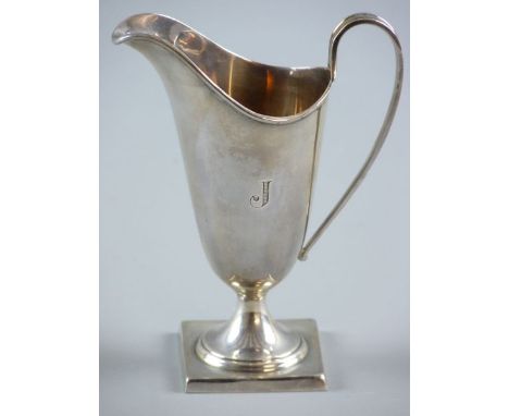 A SQUARE BASED PLAIN SILVER HELMET CREAM JUG, inscribed with the letter 'J', 3.6 ozs, Sheffield 1935