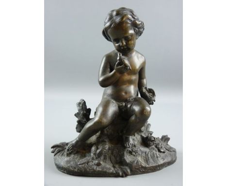 A BRONZE FIGURE OF A PUTTO, the childlike figure seated on a floral crop holding a bird in one hand and a nest with eggs in t