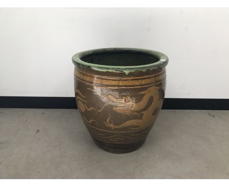 A second half 20th century Chinese stoneware planter, 49cm diameter, with dragon design