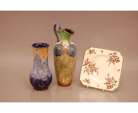 Three ceramic items of Royal Doulton, including two vases, one with a broken and repaired handle 23cm high, both AF, together
