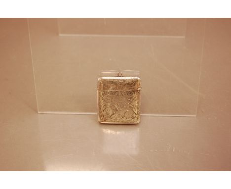 A late Victorian silver vesta case, 4.5cm high,  with engraved scrolling decoration, Birmingham 1900, probably Henry Wilkinso