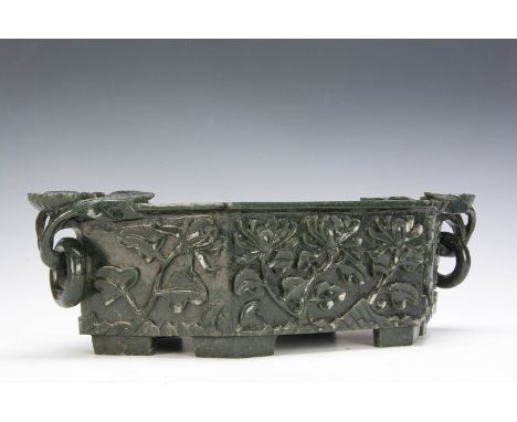 A 20th century two handled nephrite jade planter, of hexagonal shape, carved foliate decoration, two flower handles suspendin