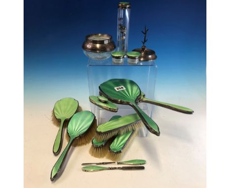 TWO GREEN ENAMELLED SILVER MOUNTED DRESSING TABLE SETS, BIRMINGHAM 1934, THE THIRTEEN PIECES TOGETHER WITH A RING STAND AND A