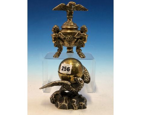 A SILVERED EAGLE BEARING A BRASS TERRESTIAL GLOBE INKWELL ON ITS SPREAD WINGS TOGETHER WITH A BRASS SPREAD EAGLE COVERED INKW