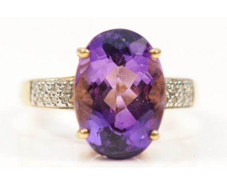 A 9ct gold amethyst cocktail ring with diamond set shoulders, 19mm x 9mm, N, 3.4g