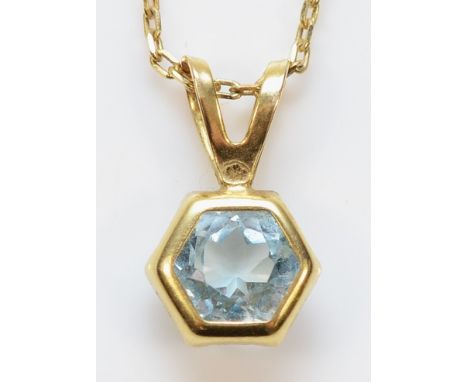 A 9ct gold blue topaz pendant on a chain, 1.1g