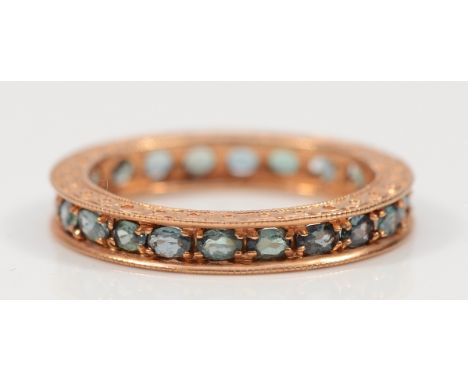 A 14K rose gold green gemstone full eternity ring, S, possibly green sapphire, 4g
