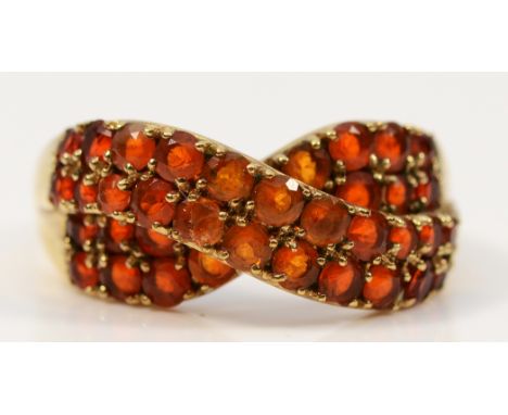 A QVC 9ct gold fire opal cross over ring, Q, 3.9g