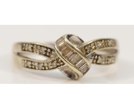 A 9ct white gold vari cut diamond cross over ring, P, 2.6g