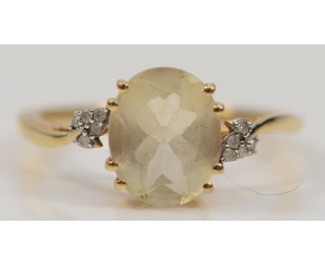 A 9ct gold citrine solitaire ring with diamond set shoulders, 10mm x 8mm citrine, P 1/2, 2.3g