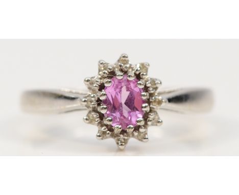 A 9ct white gold pink sapphire and diamond cluster ring, K, 2.2g