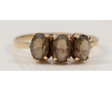 A 9ct gold smokey quartz three stone ring, hallmarks worn smooth, O 1/2, 1.5g