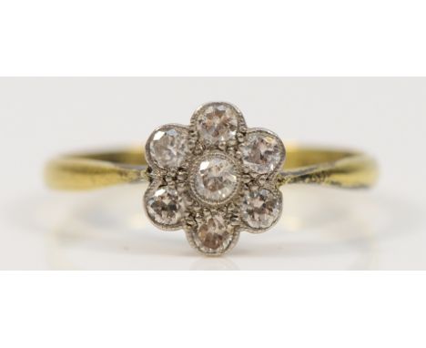 An 18ct gold and platinum brilliant cut diamond floral cluster ring, M, 1.9g Condition- 7mm diameter cluster, there are no cr