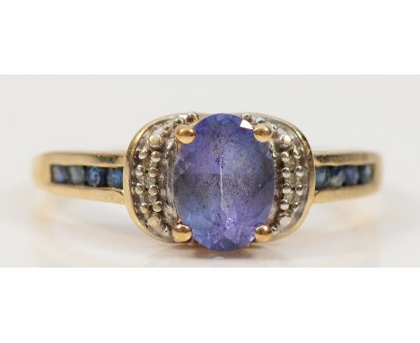 A 9ct gold tanzanite and diamond dress ring with sapphire set shoulders, S, 2.6g
