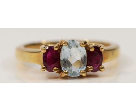 A 9ct gold ruby and aquamarine three stone ring, M, 3.3g